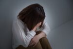 吐き気をおさえる女性